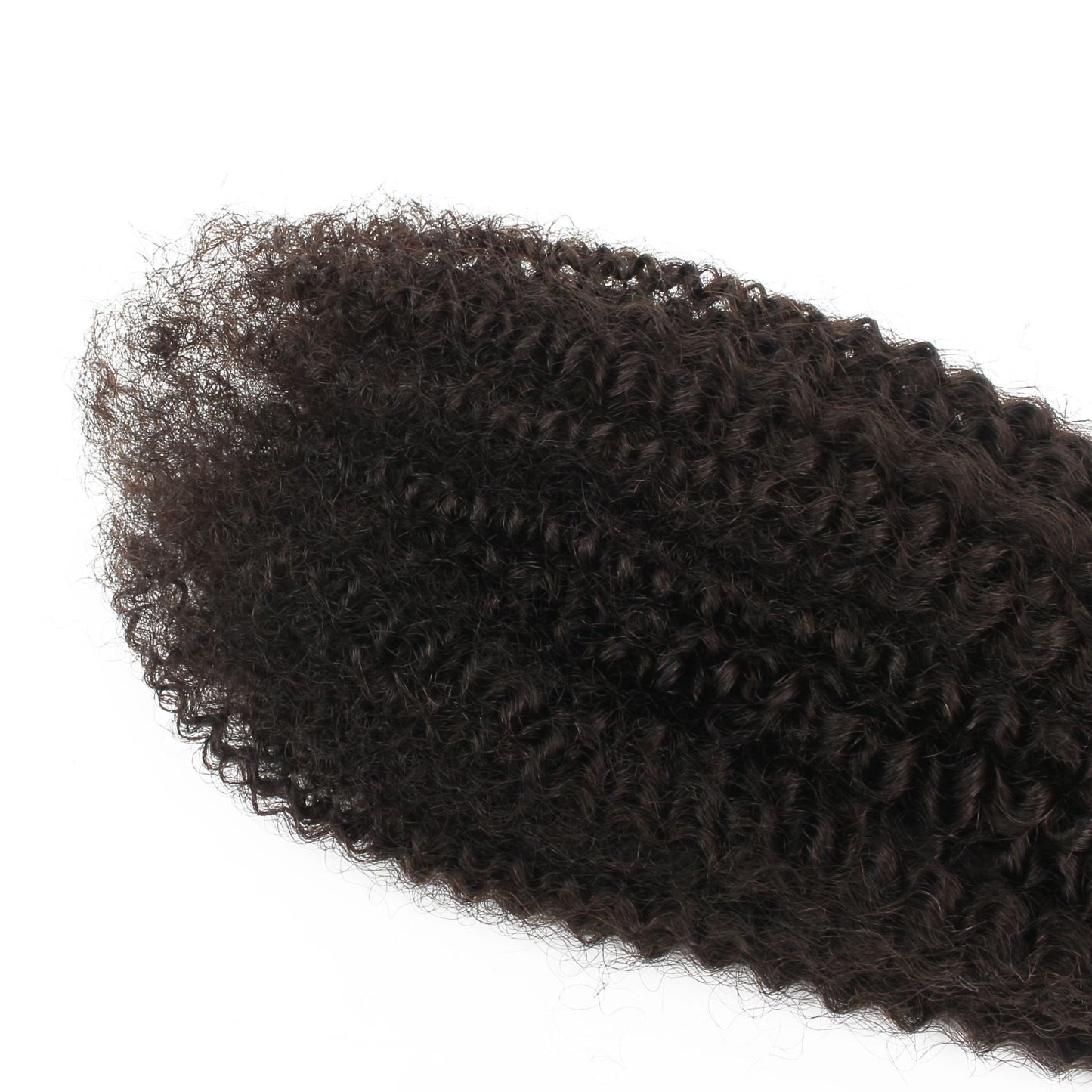 Macro view of the tight afro kinky curl pattern on natural black curly hair extensions with loose ends spread across a white surface