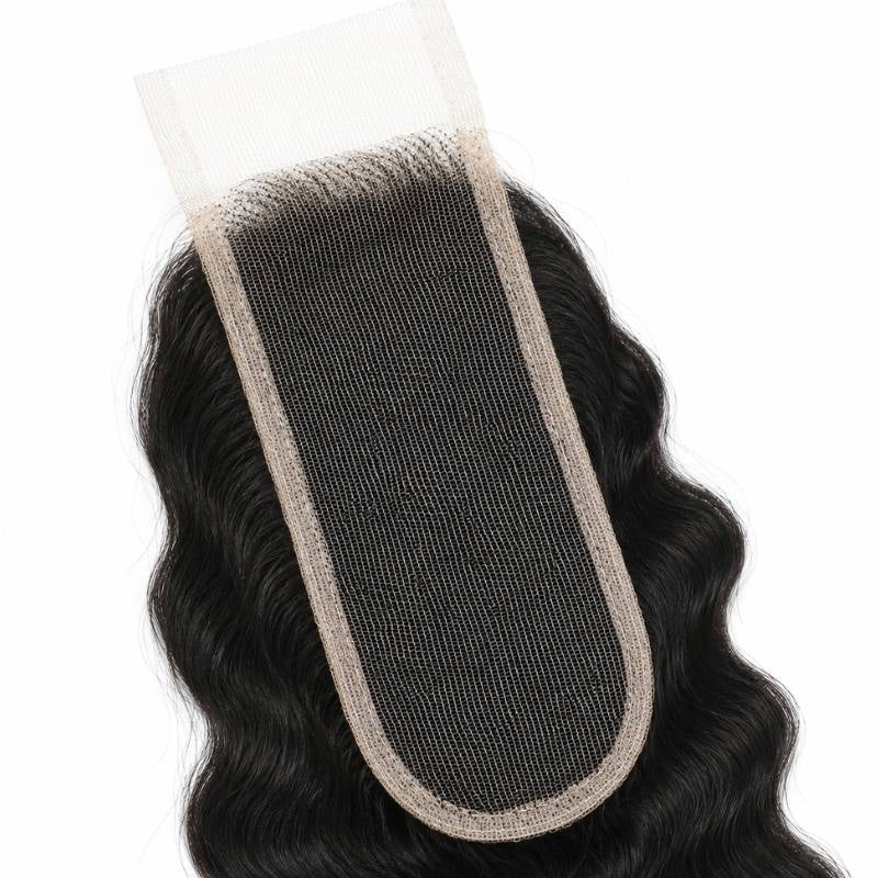 Close-up of the narrow lace strip and bound edge on a natural black 2x6 transparent closure with deep wave hair extensions on either side