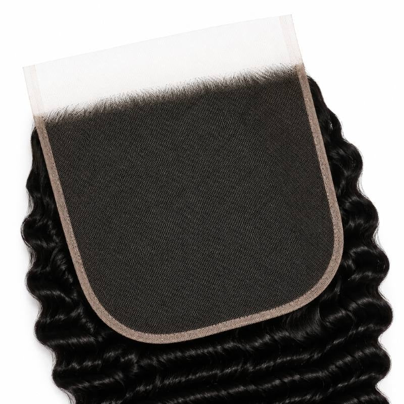 Underside of the 7x7 HD lace closure showing the lace base and bound edge with natural black deep wave hair extensions behind