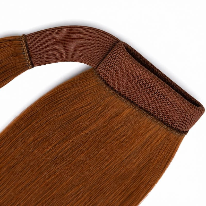 Close-up of the wrap around strap and mesh band on auburn straight ponytail hair extensions laid flat