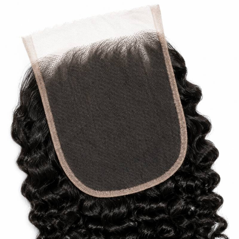 Close-up of the lace base on natural black curly lace closure hair extensions with tight curls framing the panel