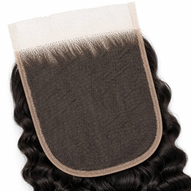 Macro close-up of the lace base and knotted hairline on natural black spiral wave lace closure hair extensions
