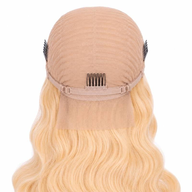 Inside back of the cap on a blonde body wave human hair wig showing three combs, the adjustable strap and the mesh nape panel