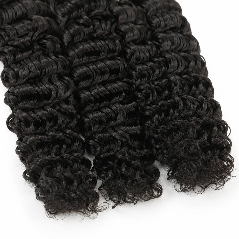 Close-up of the ends of natural black curly sew-in hair extensions showing tight spiral curls breaking apart at the tips