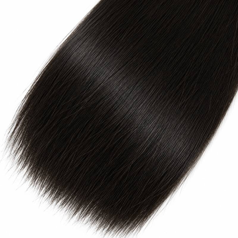 Close-up of the rounded end of a bundle of natural black straight sew-in hair extensions on a white background