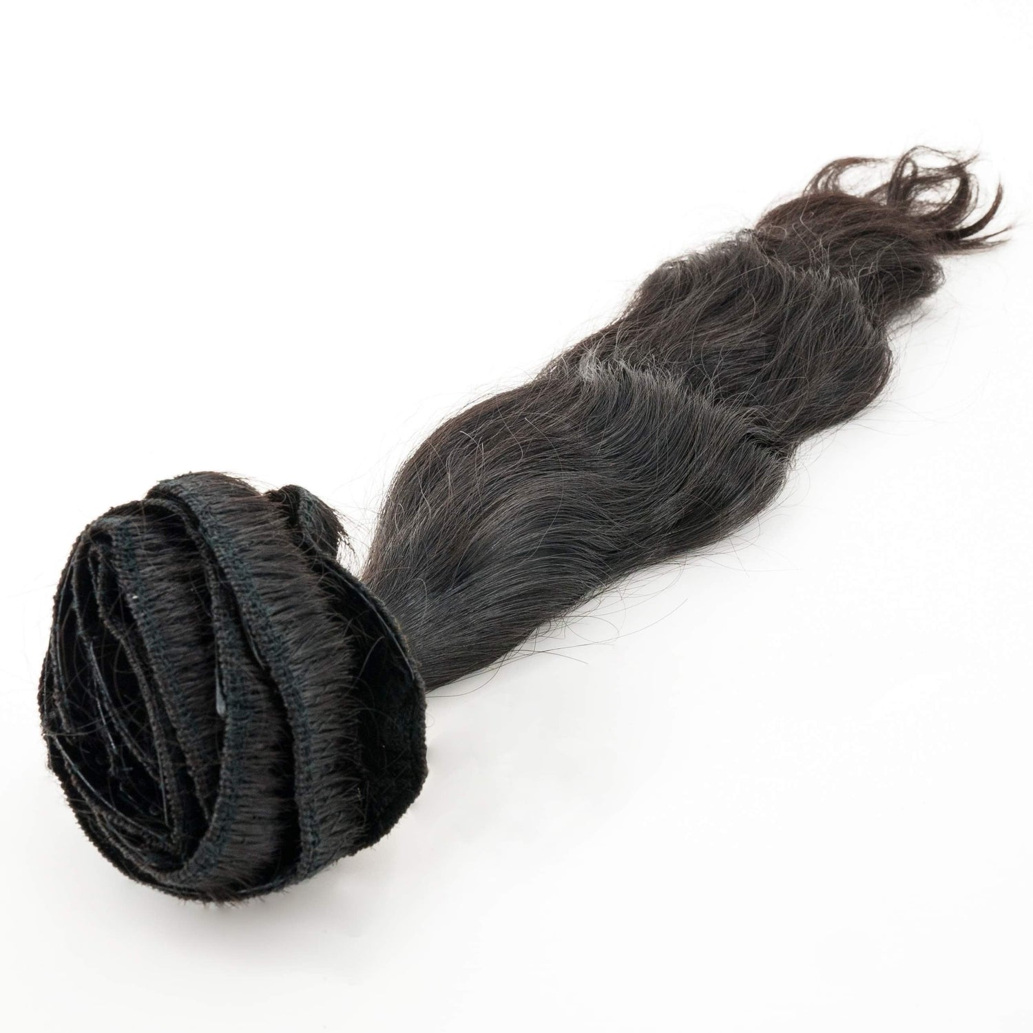 Seamless clip-in human hair extensions with silicone grip clips lying flat