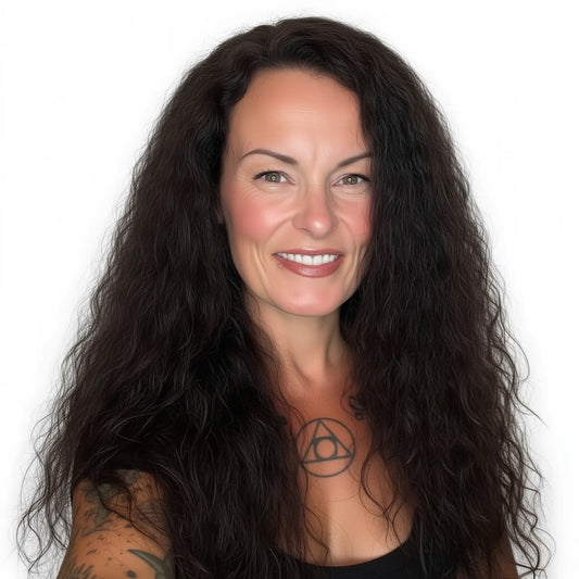 Woman with long dark hair and tattoos on a white background