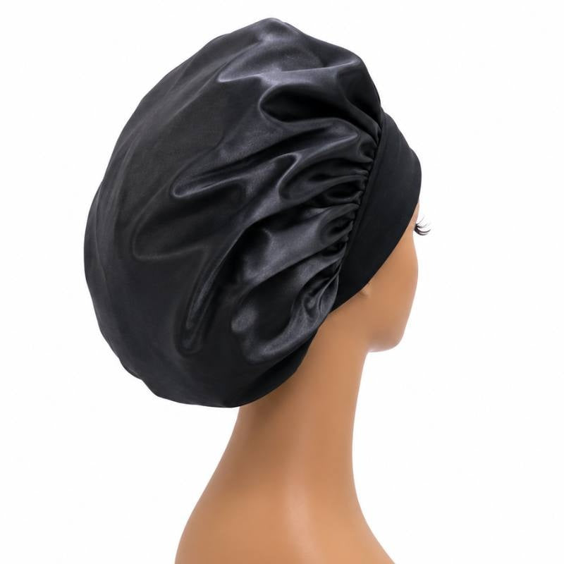 Back view of the black silk bonnet on a mannequin head showing the full gathered crown that covers hair extensions while sleeping