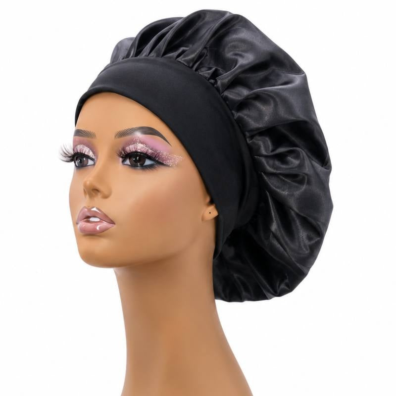 Black silk bonnet on a mannequin head showing the rounded gathered crown and wide elastic band used to protect hair extensions overnight