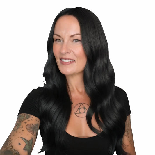 Woman with long black hair and tattoos on a white background