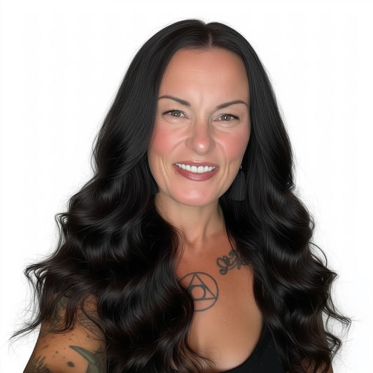 Woman with long black hair and tattoos on a white background