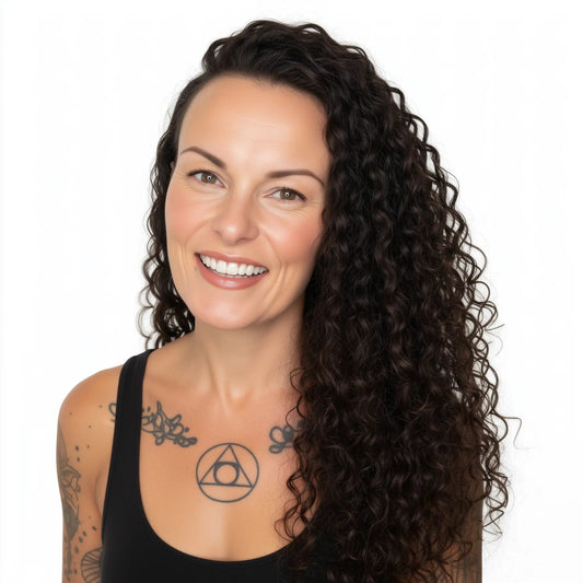 Woman with long, curly hair smiling on a white background