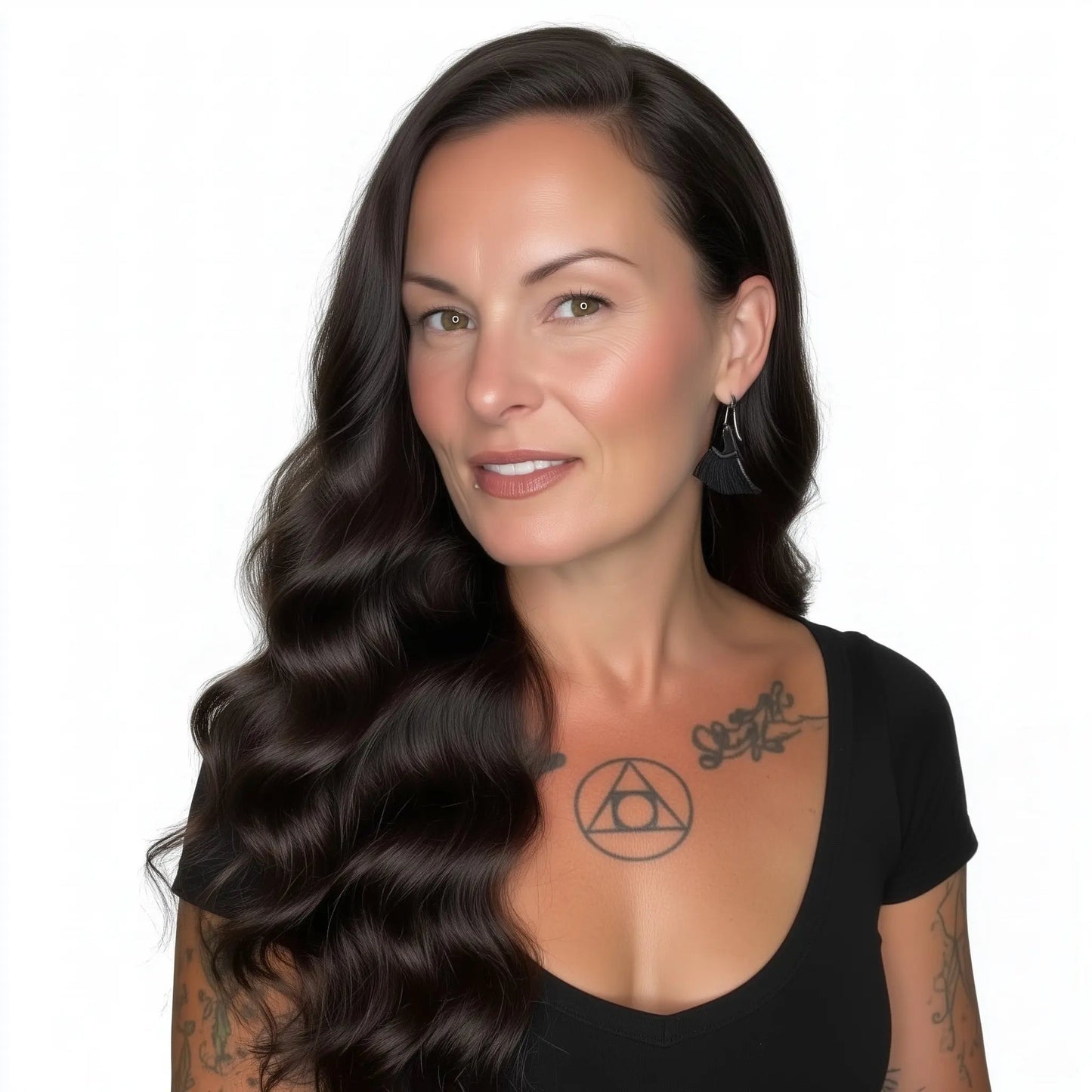Woman with long wavy hair and tattoos on a white background