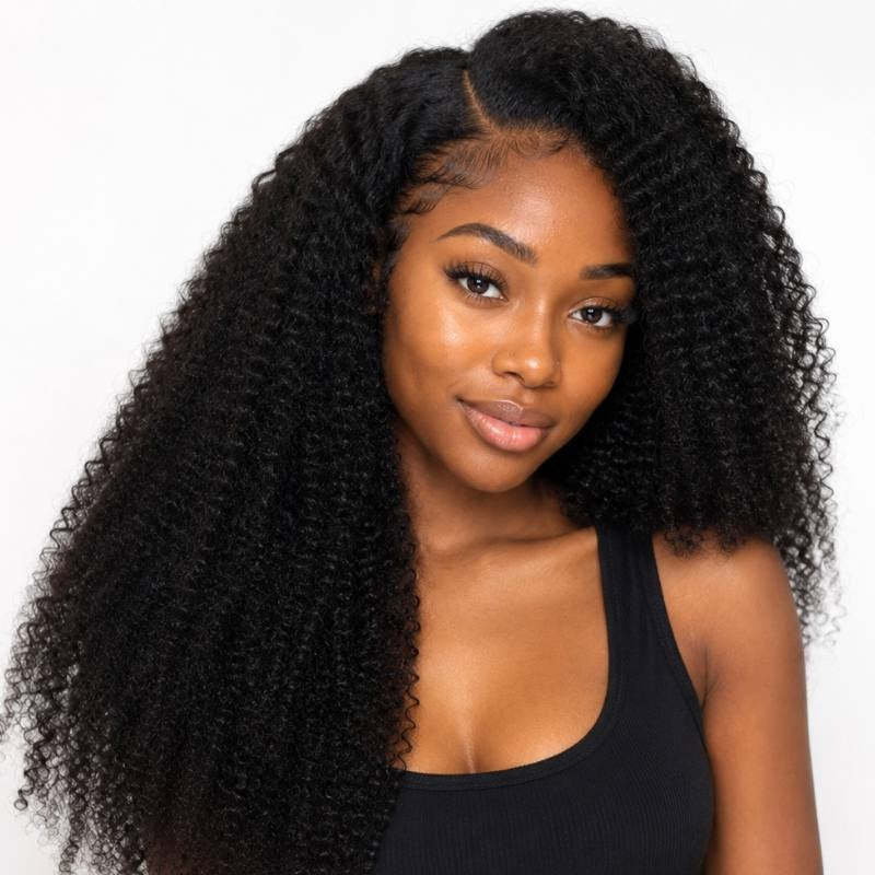 Model facing forward wearing natural black afro kinky curly clip-in hair extensions with a centre part and full volume through the lengths
