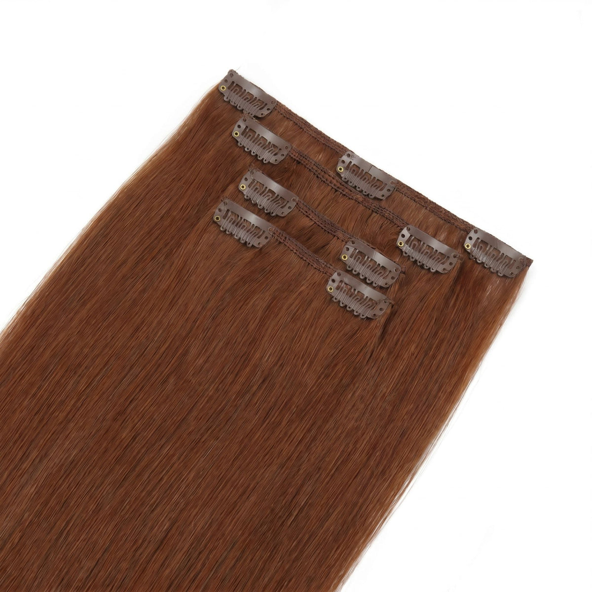 Full set of copper straight clip-in hair extensions laid flat with the thin bands and snap clips facing up on a white surface