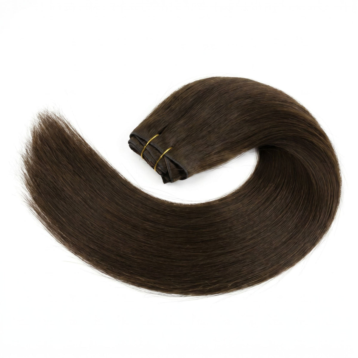 Dark brown straight clip-in hair extensions laid in a wide curve on a white surface with the wefts tied together by gold thread
