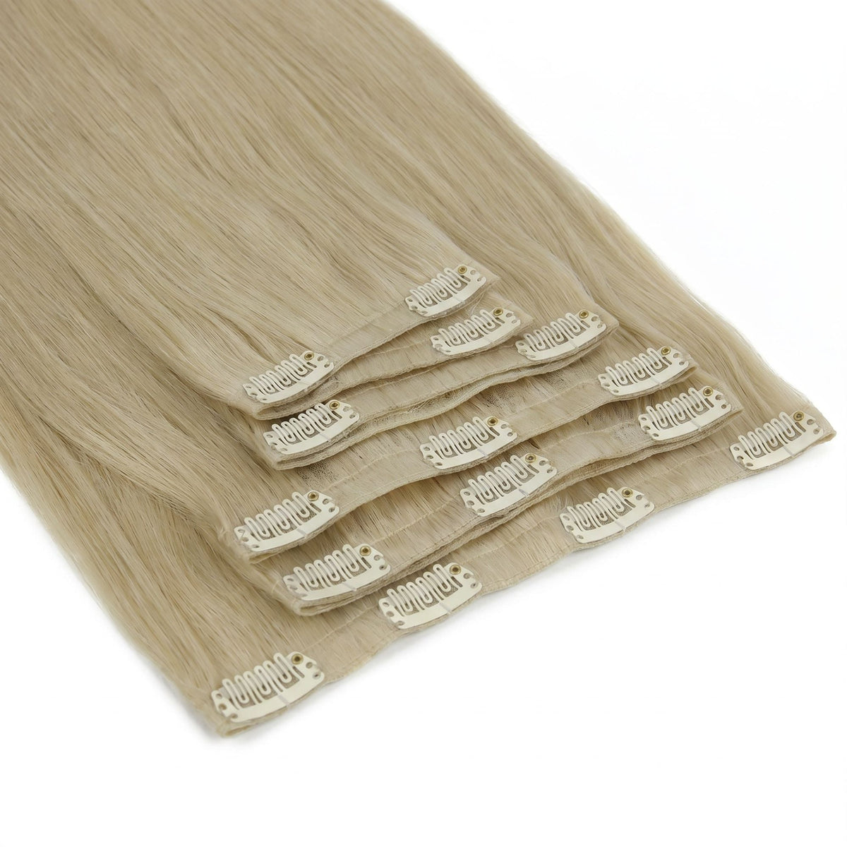 Honey blonde straight clip-in hair extensions fanned at an angle so every snap clip and thin band across the set is visible