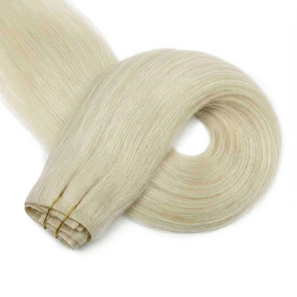 Platinum blonde straight clip-in hair extensions coiled into a ring beside the folded wefts held by two gold thread ties