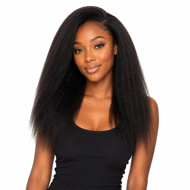 Model facing forward wearing natural black kinky straight clip-in hair extensions with a centre part and full body through the lengths