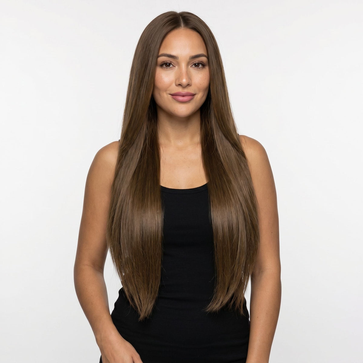 Model facing forward wearing long straight chocolate brown clip-in hair extensions parted in the centre against a white studio backdrop