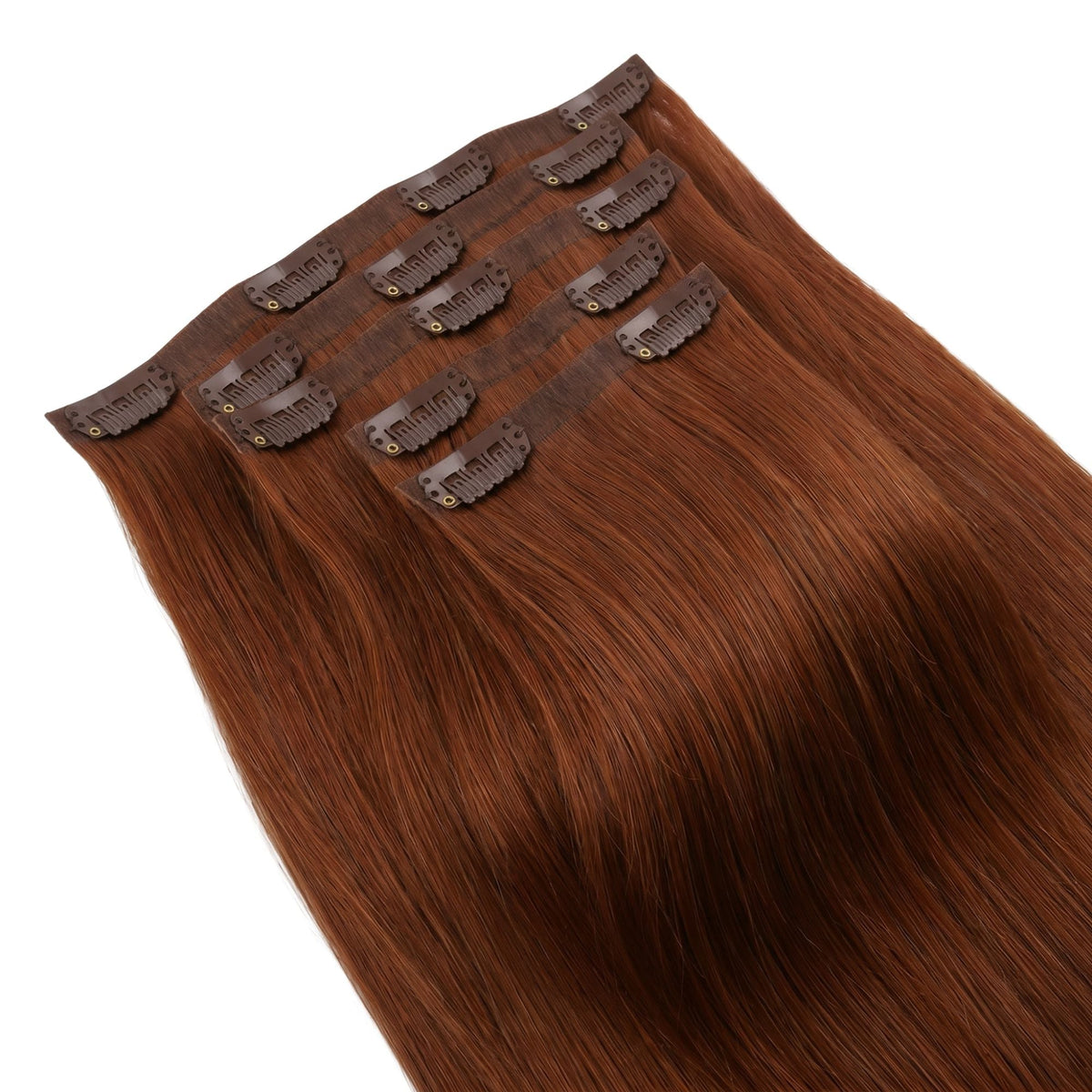 Full set of copper straight clip-in hair extensions laid flat with the seamless bands and snap clips facing up