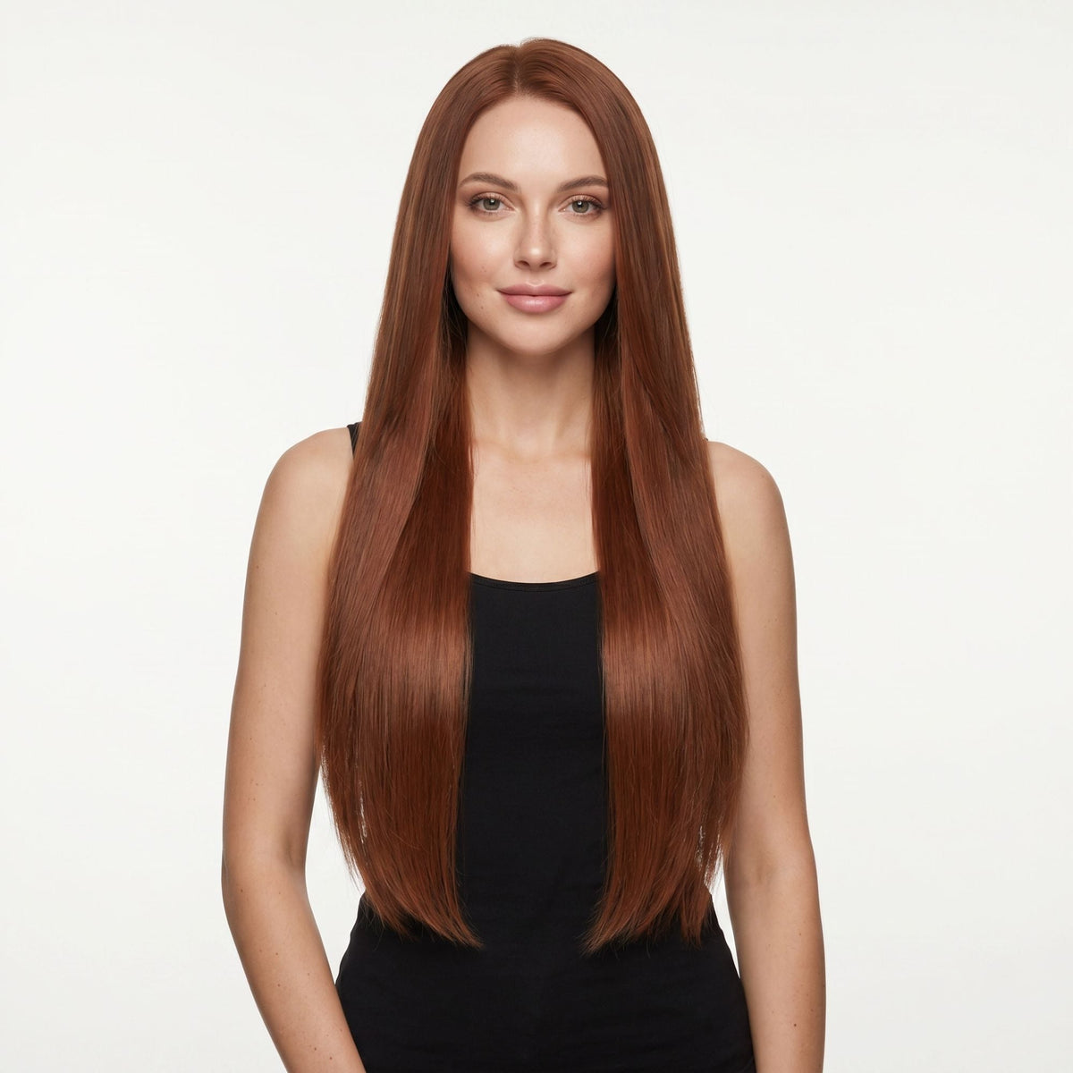 Model facing forward wearing long straight copper clip-in hair extensions parted in the centre against a white studio backdrop