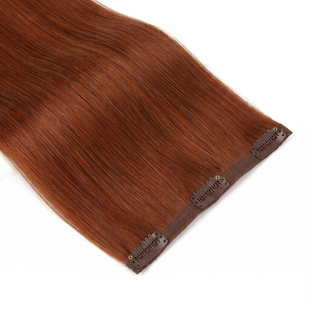 Close-up of a single seamless weft of copper straight clip-in hair extensions showing three snap clips along the flat band