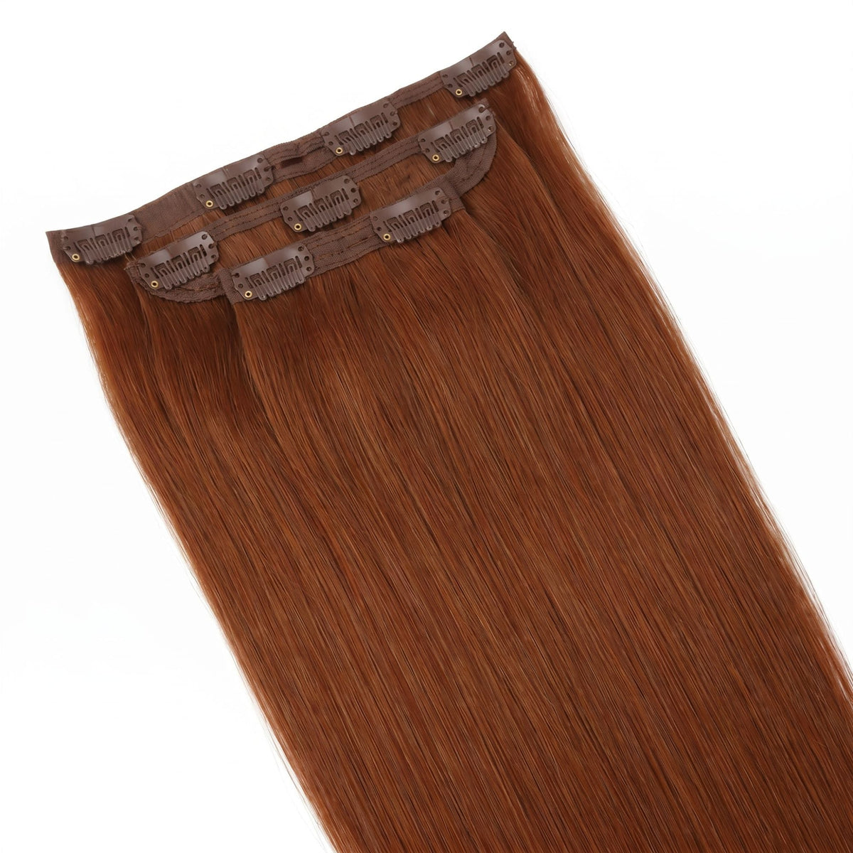 Copper straight clip-in hair extensions stacked so the seamless bands and clips gather at the top of the frame