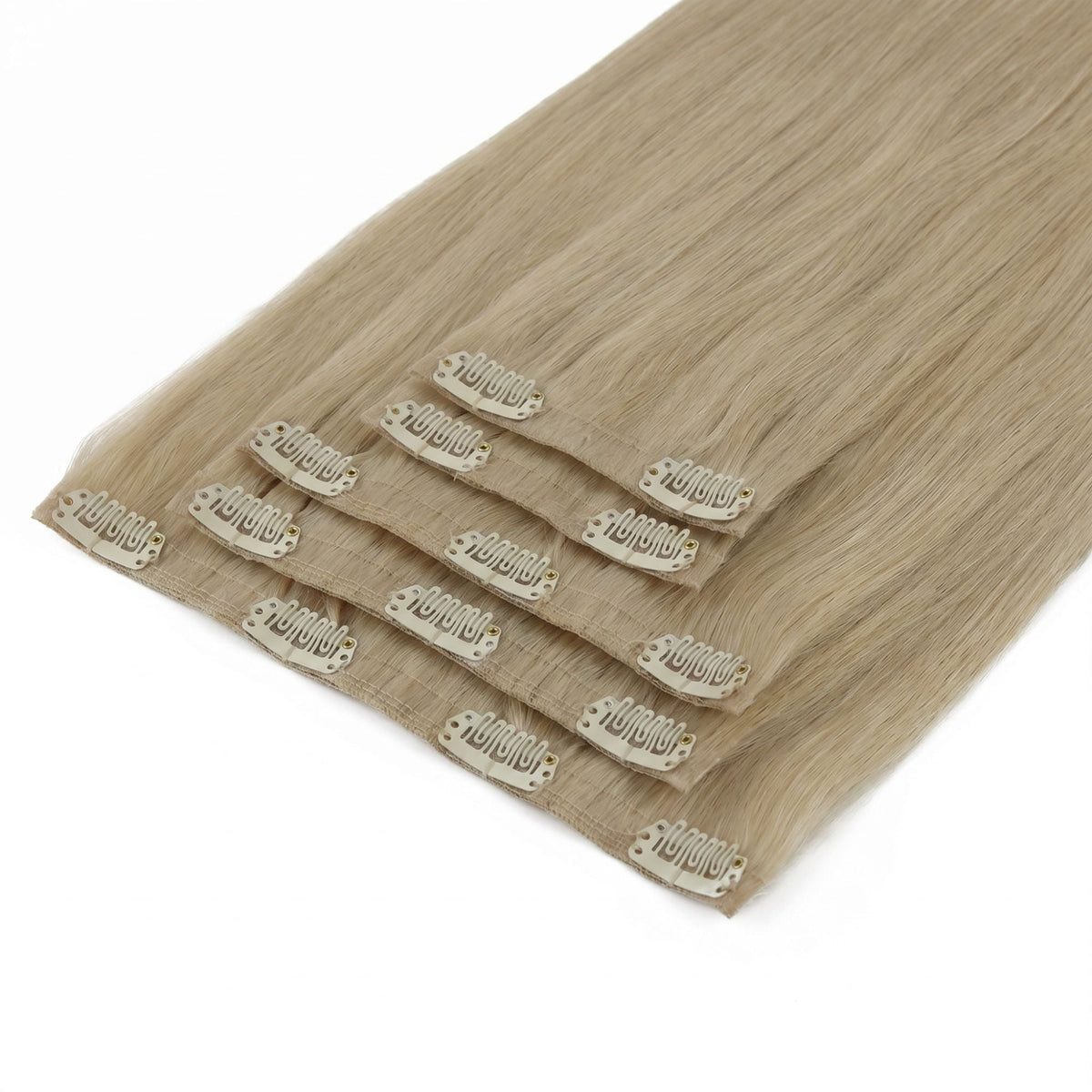 Full set of honey blonde straight clip-in hair extensions laid flat with the seamless bands and pale snap clips facing up