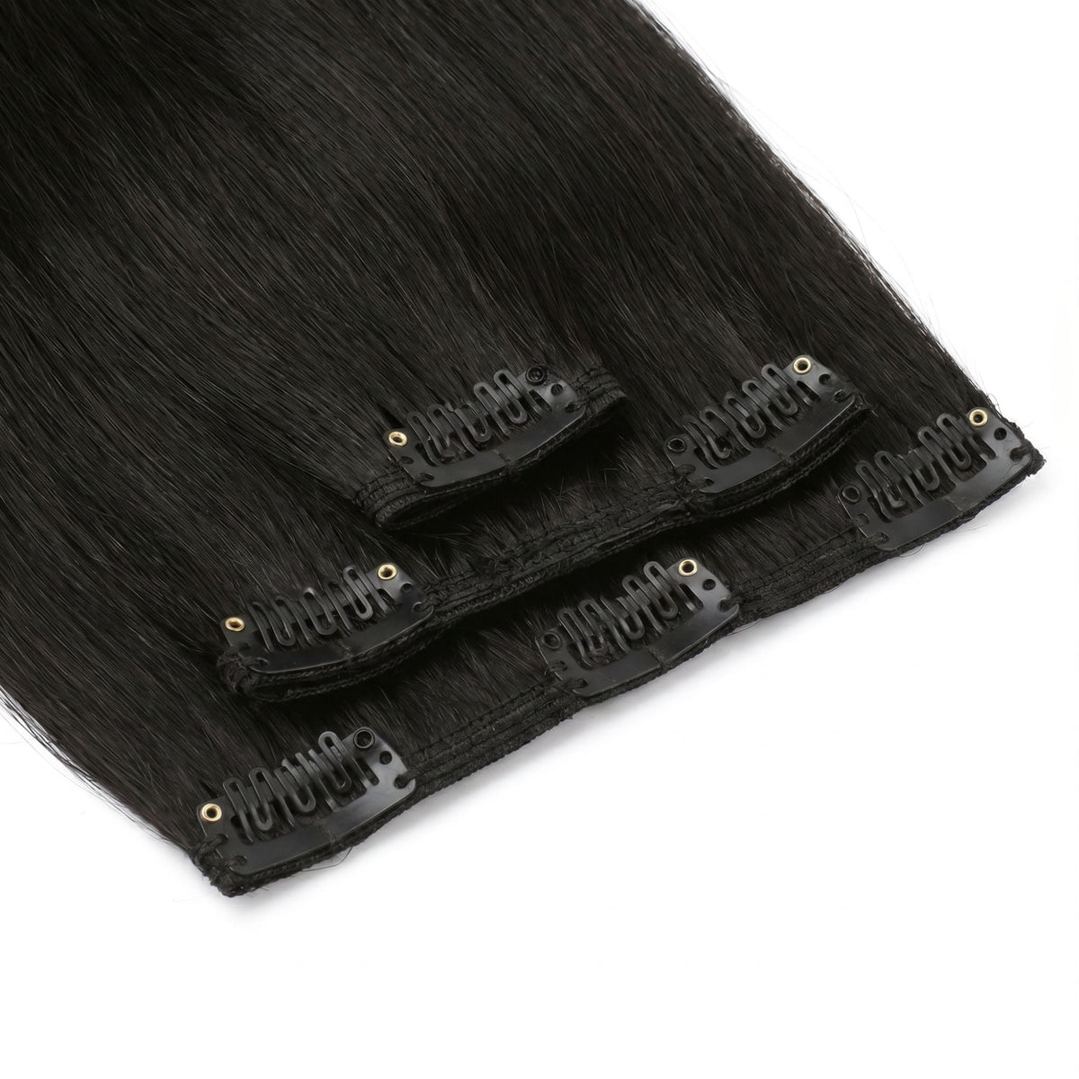 Close-up of the flat seamless wefts on off black straight clip-in hair extensions with black snap clips attached