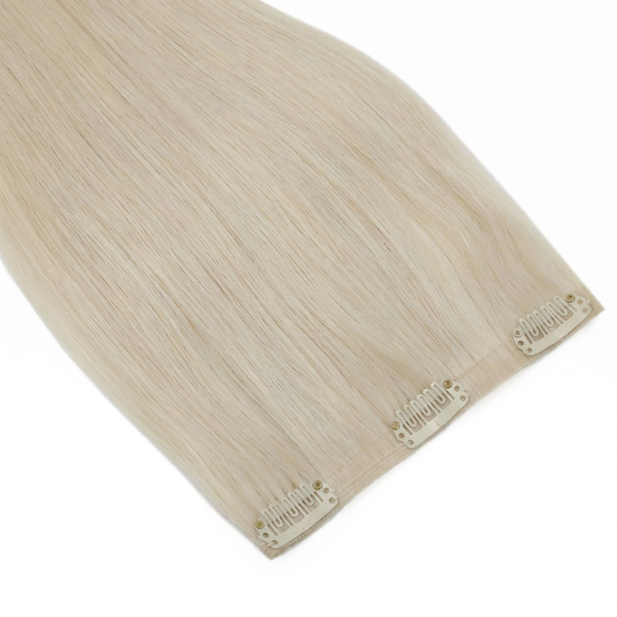 Close-up of the flat weft band and snap clips on platinum blonde straight clip-in hair extensions resting on a white surface