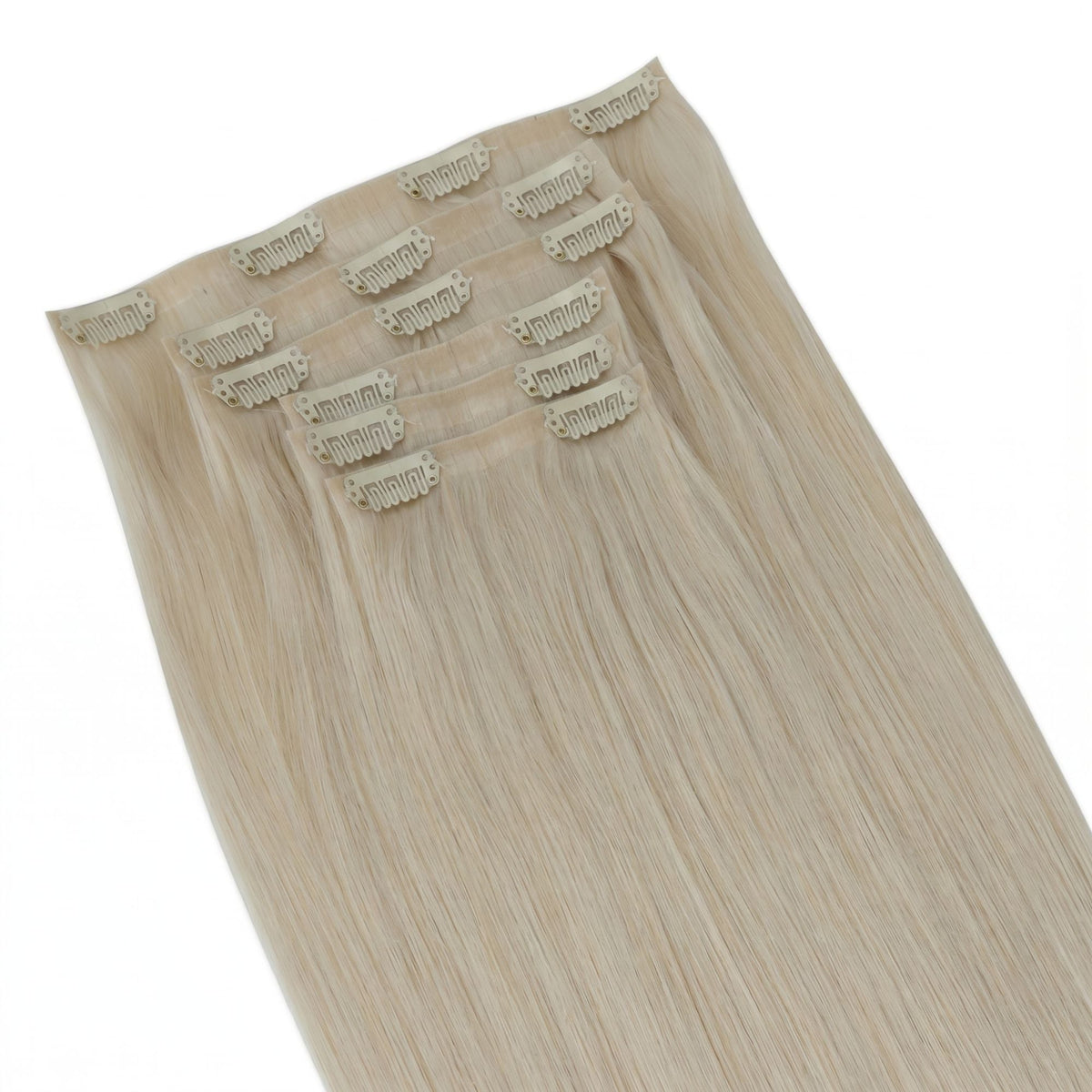 Overhead view of platinum blonde straight clip-in hair extensions fanned out with the clipped weft tops aligned across the frame