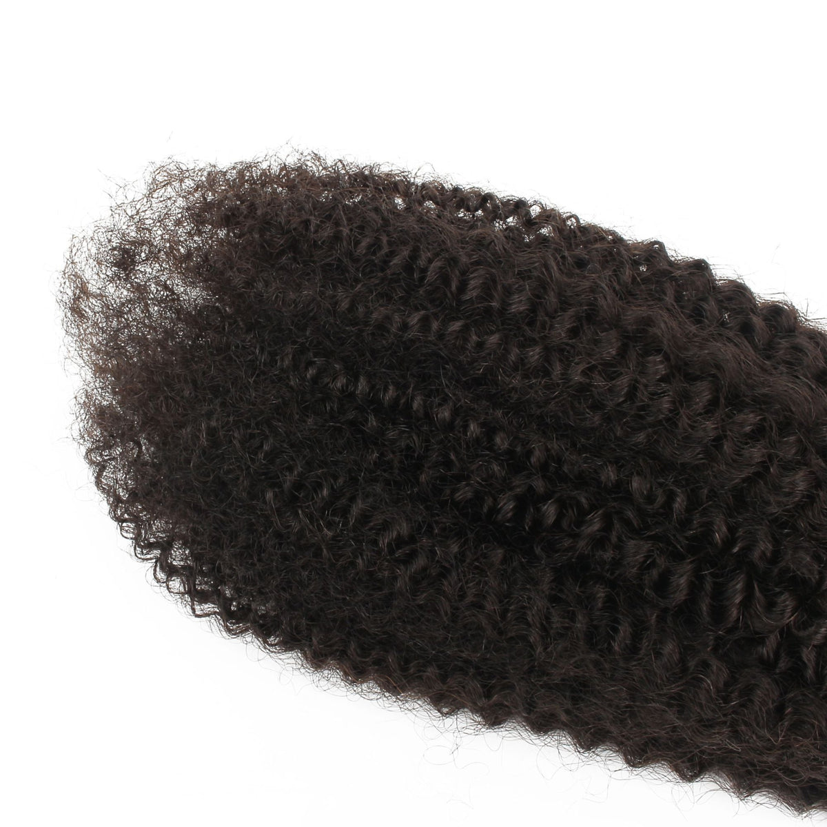 Macro view of the tight afro kinky curl pattern on natural black curly hair extensions with loose ends spread across a white surface