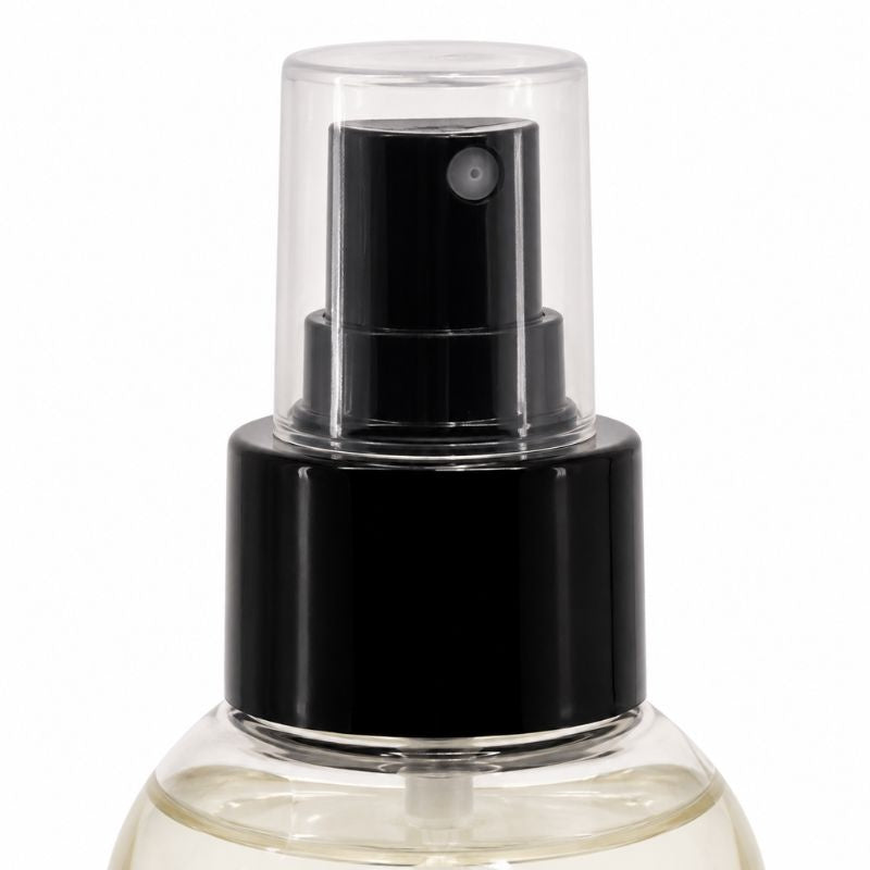 Detail of the capped pump head on the citrus adhesive remover bottle, a lace cleaning product for wigs and hair extensions
