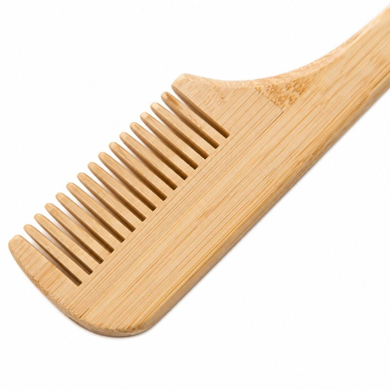 Close-up of the wooden comb teeth on the reverse of the 3-in-1 edge tool used for parting and styling hair extensions
