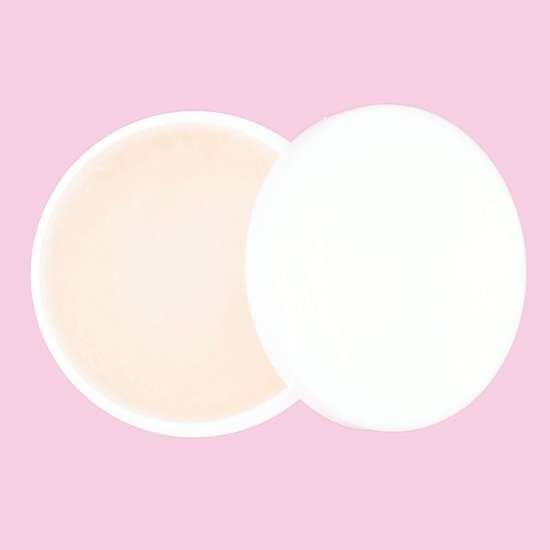 Open edge control jar and its lid photographed from above on a pink backdrop, a smoothing gel used alongside hair extensions