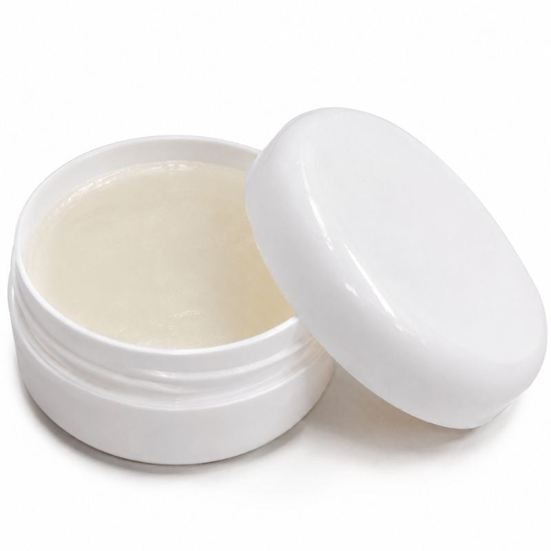 Open white jar of pale edge control gel with the lid propped beside it, a laying product used with wigs and hair extensions
