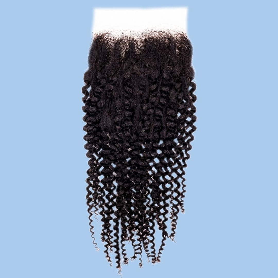 Transparent lace closure with natural black afro kinky curly hair extensions shown on a pale blue backdrop with corkscrew curls hanging