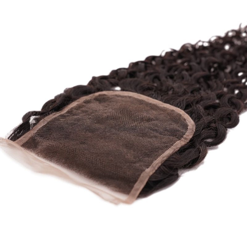 Underside of the transparent lace closure on a white background, showing the lace base and the natural black curly hair extensions attached to it