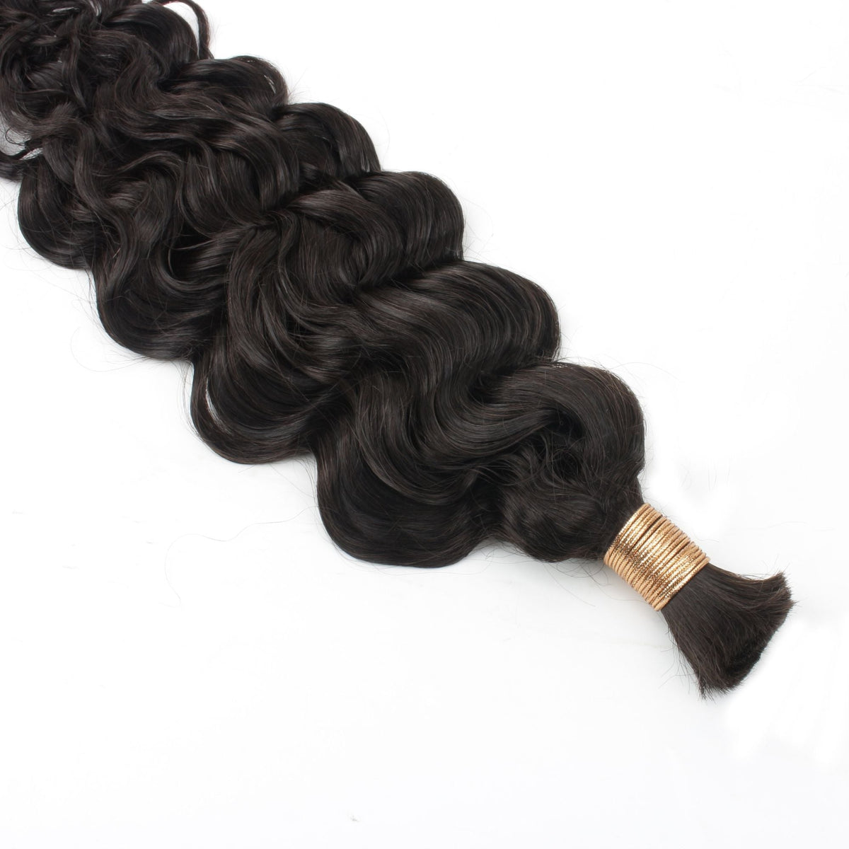 Bulk bundle of natural black beach wave braiding hair extensions tied with a gold band and laid on a white surface with no weft
