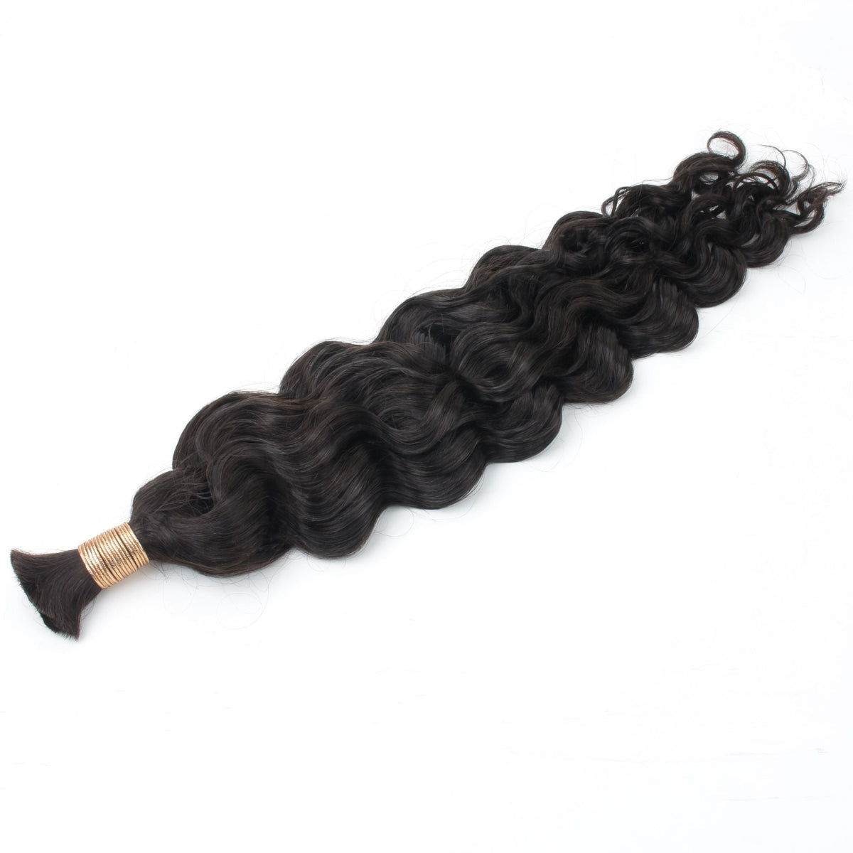 Full bulk bundle of natural black beach wave braiding hair extensions laid diagonally on white, showing the wave from the band to the ends