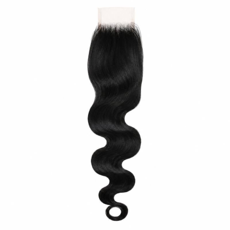 Jet black body wave hair extensions on an HD lace closure hanging against a white background with the wave curling at the end