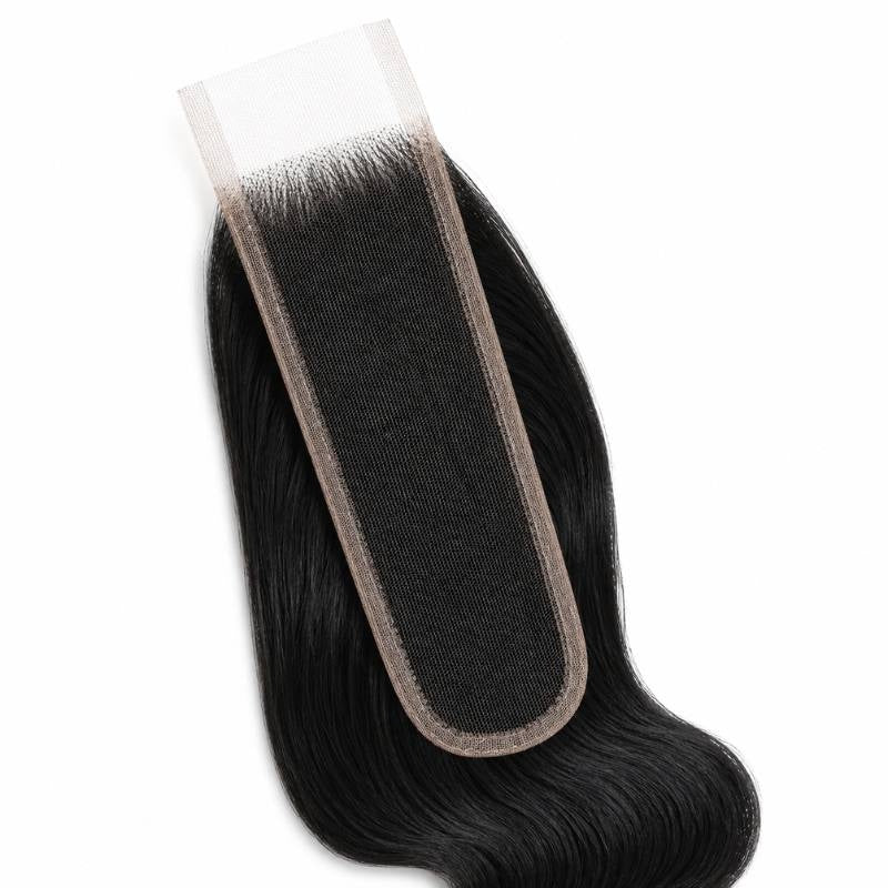 Close-up of the narrow HD lace closure panel with jet black body wave hair extensions knotted along both sides