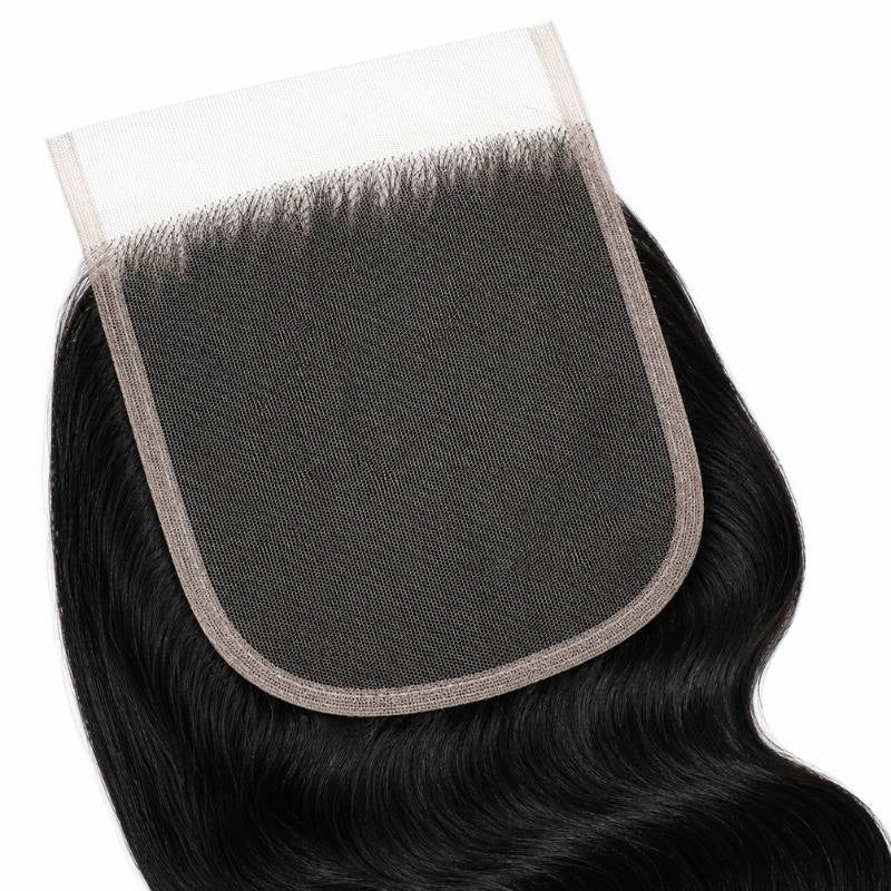 Close-up of the square HD lace closure panel with jet black body wave hair extensions knotted around the border