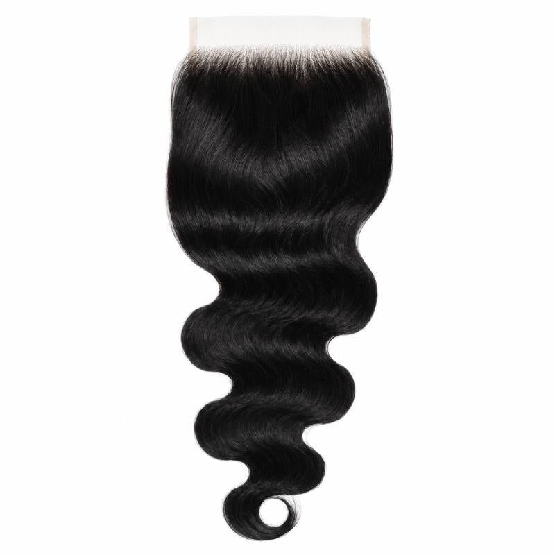 Jet black body wave hair extensions on a wide square HD lace closure hanging against a white background with a curl at the tip