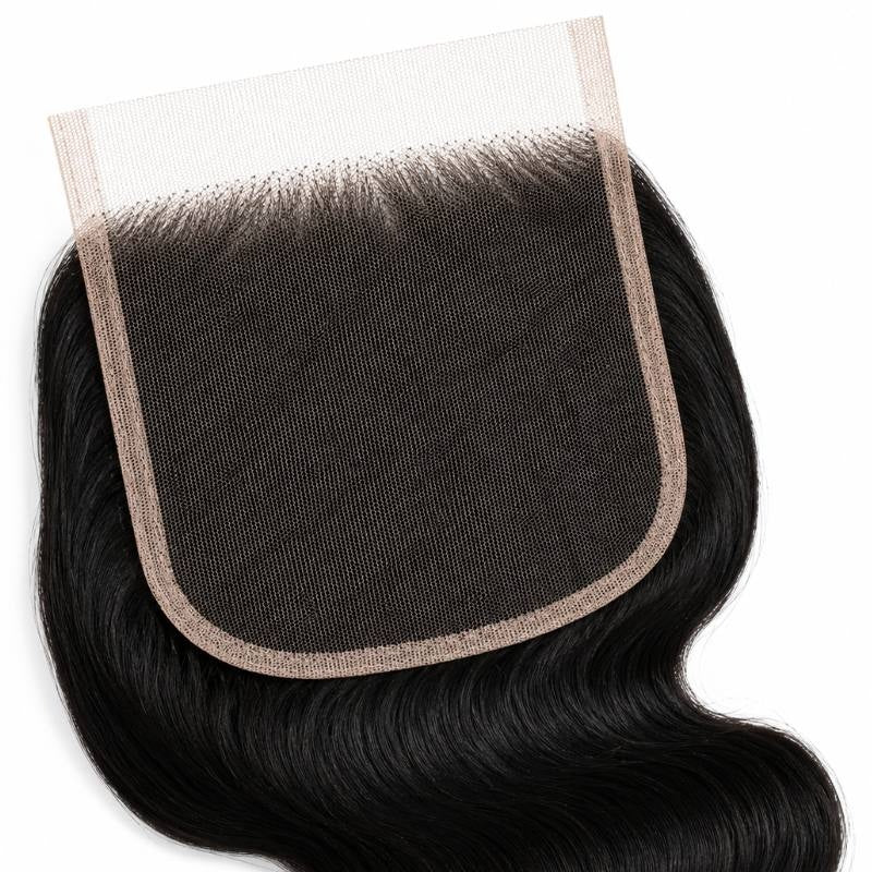 Close-up of the wide square HD lace closure panel with jet black body wave hair extensions knotted along the hairline