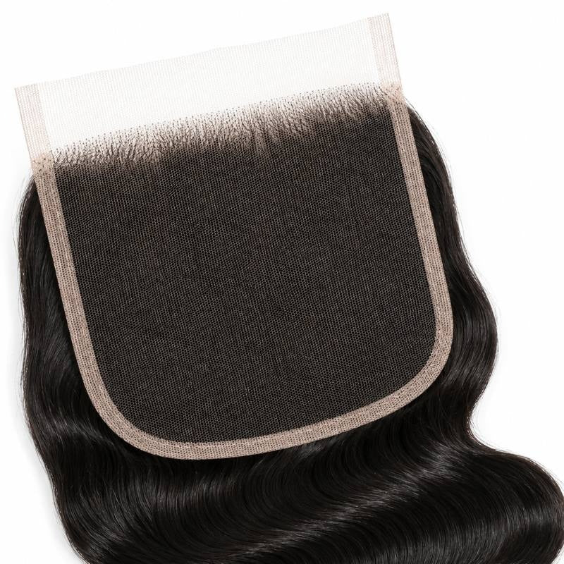 Close-up of the wide square HD lace closure panel with natural black body wave hair extensions knotted along the hairline