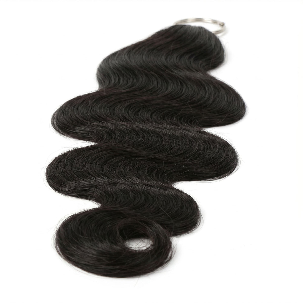 Close view of the S shaped wave running through a natural black body wave crochet hank of hair extensions hanging from its ring
