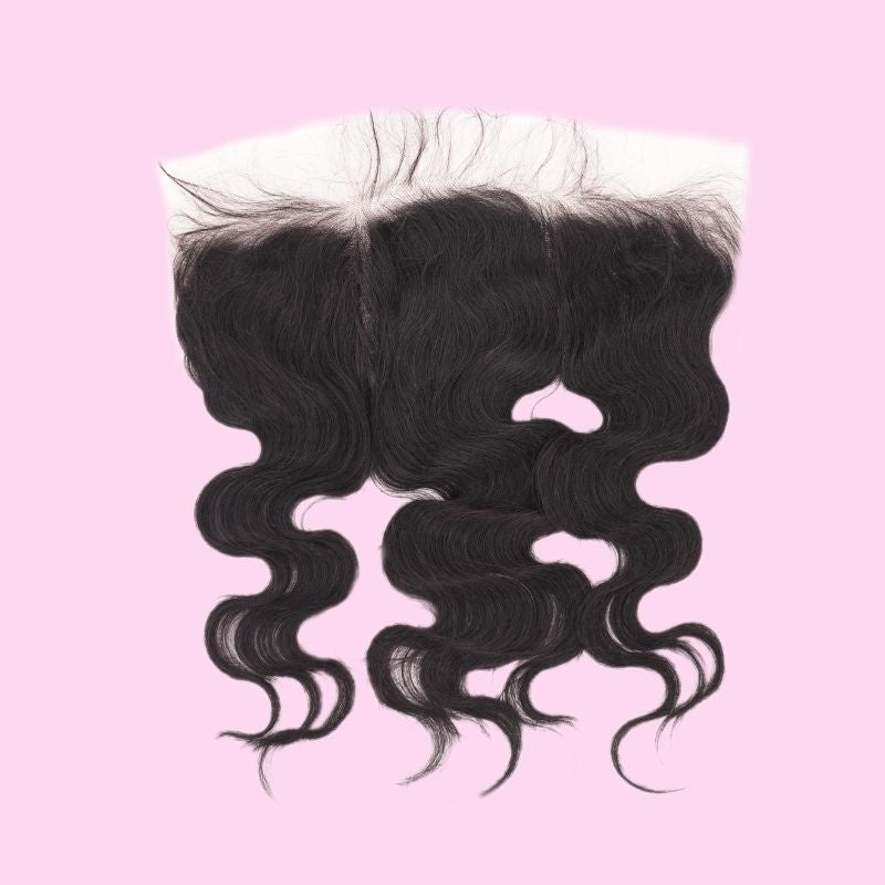 Natural black body wave HD lace frontal on a pink background showing the hairline and the parting space of the hair extensions
