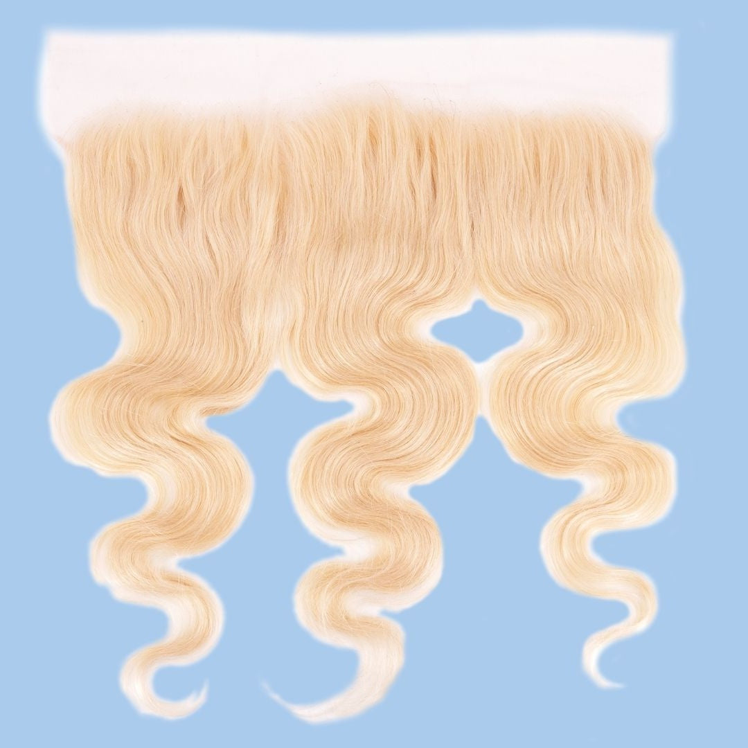 Blonde 613 body wave transparent frontal on a light blue background showing the lace band and the waved lengths of the hair extensions
